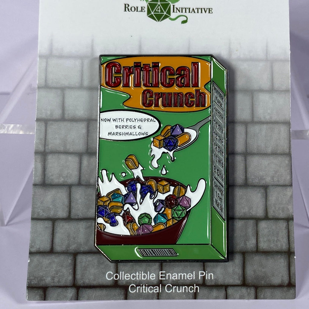 A soft enamel pin depicting a box of Critical Crunch cereal, now part of a balanced20 breakfast!